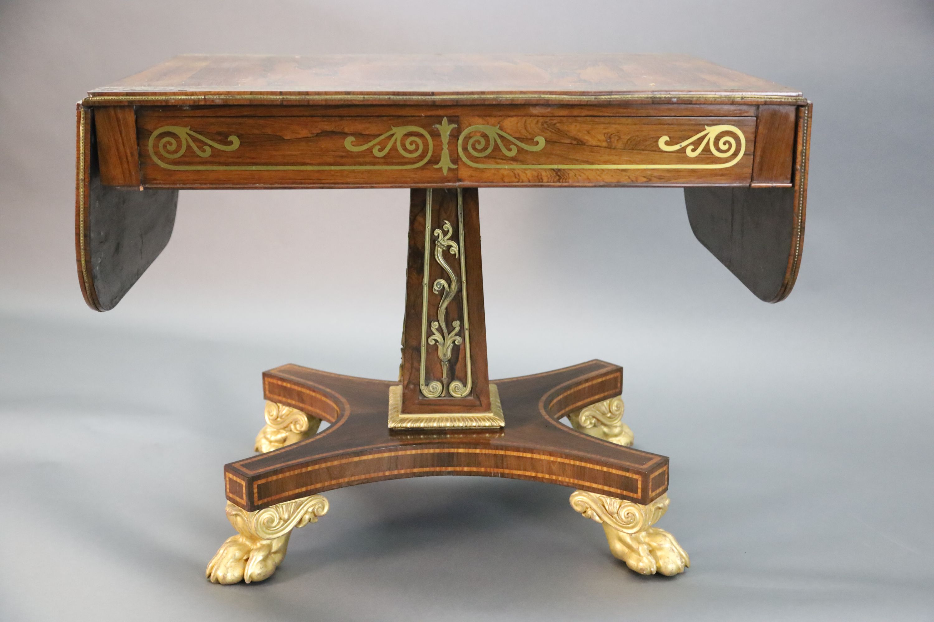 A Regency brass inset rosewood sofa table, W.3ft 2in. D.2ft 3in. opens out to 4ft 11in. H.2ft 4in.